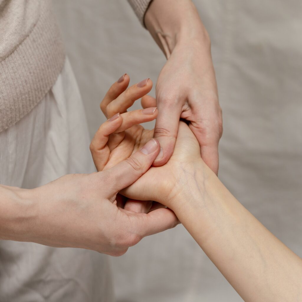 close-up-therapist-massaging-palm